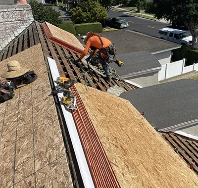 Roofing contractors installing new roof system on residential home in Los Angeles