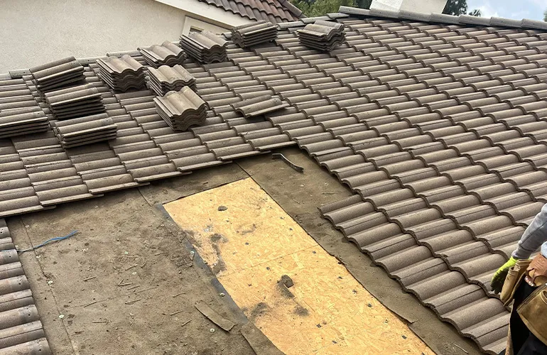 Tile roof repair with underlayment installation by 3B Roofing in Los Angeles County showing clay roof tiles being replaced and secured to fix damage and prevent leaks