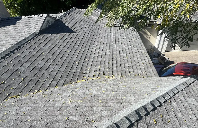 Residential asphalt shingle roof with hip and valley design and dormer window showing debris buildup that may need cleaning by 3B Roofing in Los Angeles County