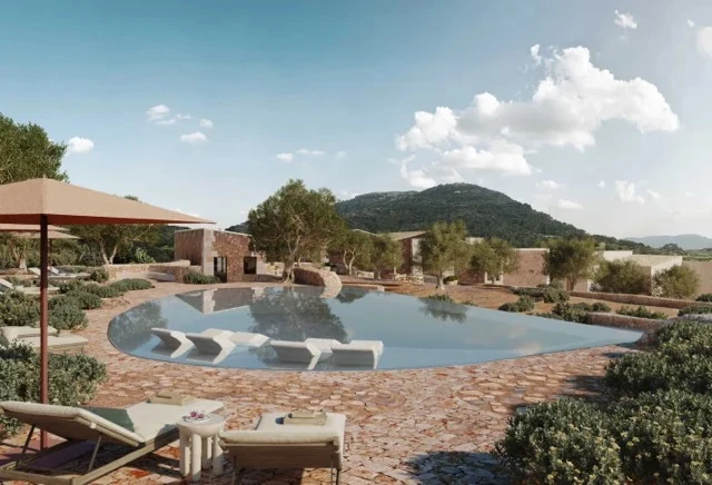 Stone-edged pool, olive trees and low rustic buildings at Vestige Binidufà in northern Menorca