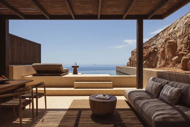 Suite terrace at Gundari with shaded lounge seating and a private infinity pool over the Aegean