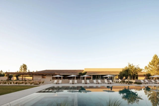 Wide sandy beach, dunes and a low beach club building on Portugal’s Comporta coastline