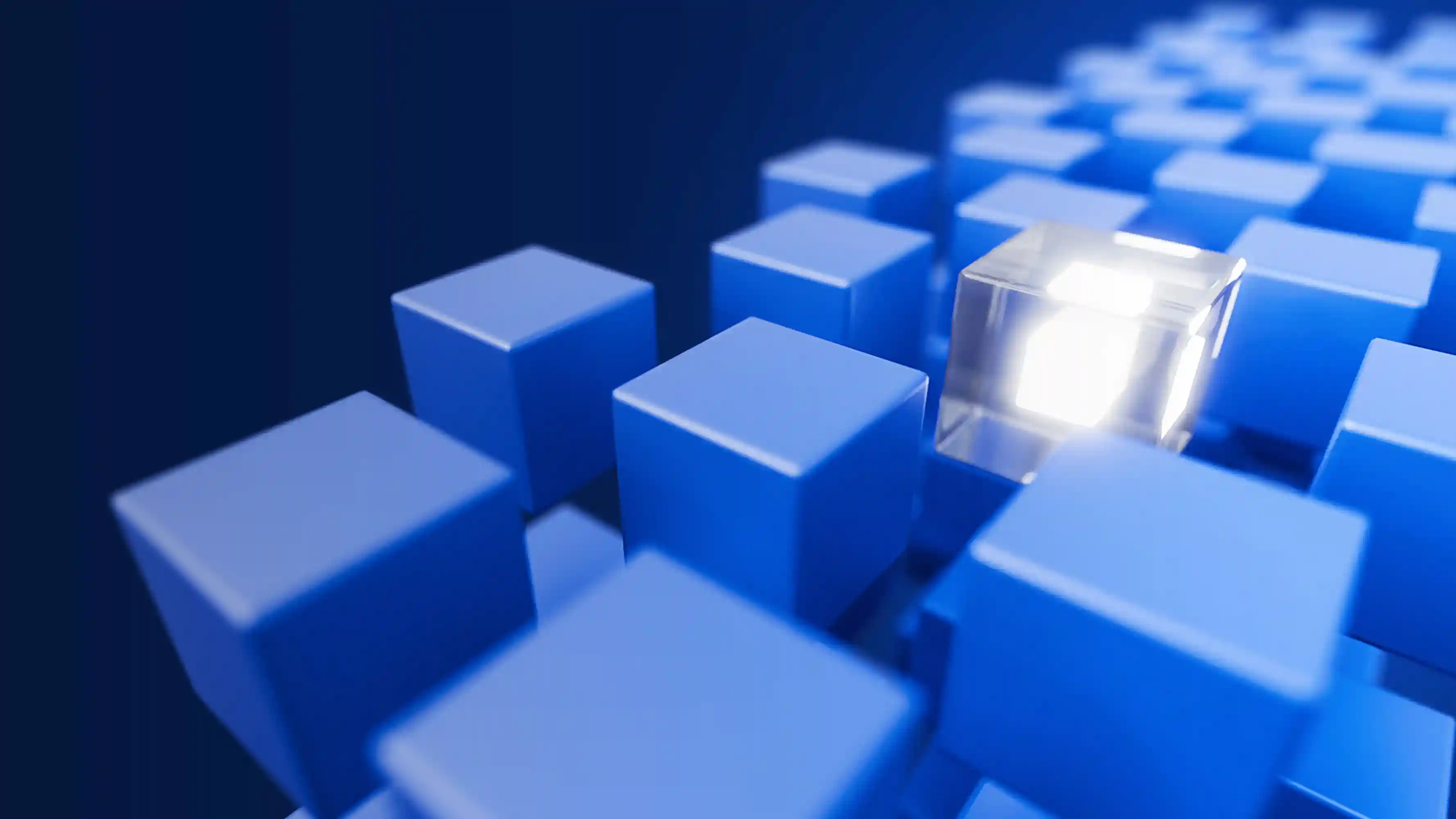 A glowing transparent cube among a grid of solid blue cubes on a dark blue background, representing standing out or uniqueness.