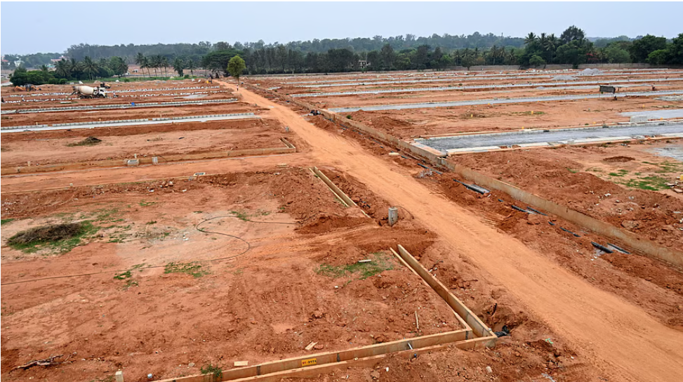 Aerial view of a large partly developed BDA layout on Bengaluru's northern edge with laid-out roads and vacant sites