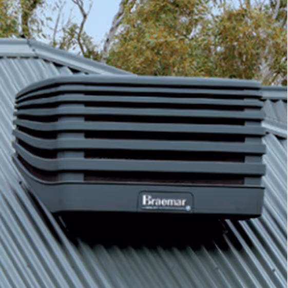 Black Braemar branded evaporative cooler unit mounted on a corrugated metal roof with trees in background.