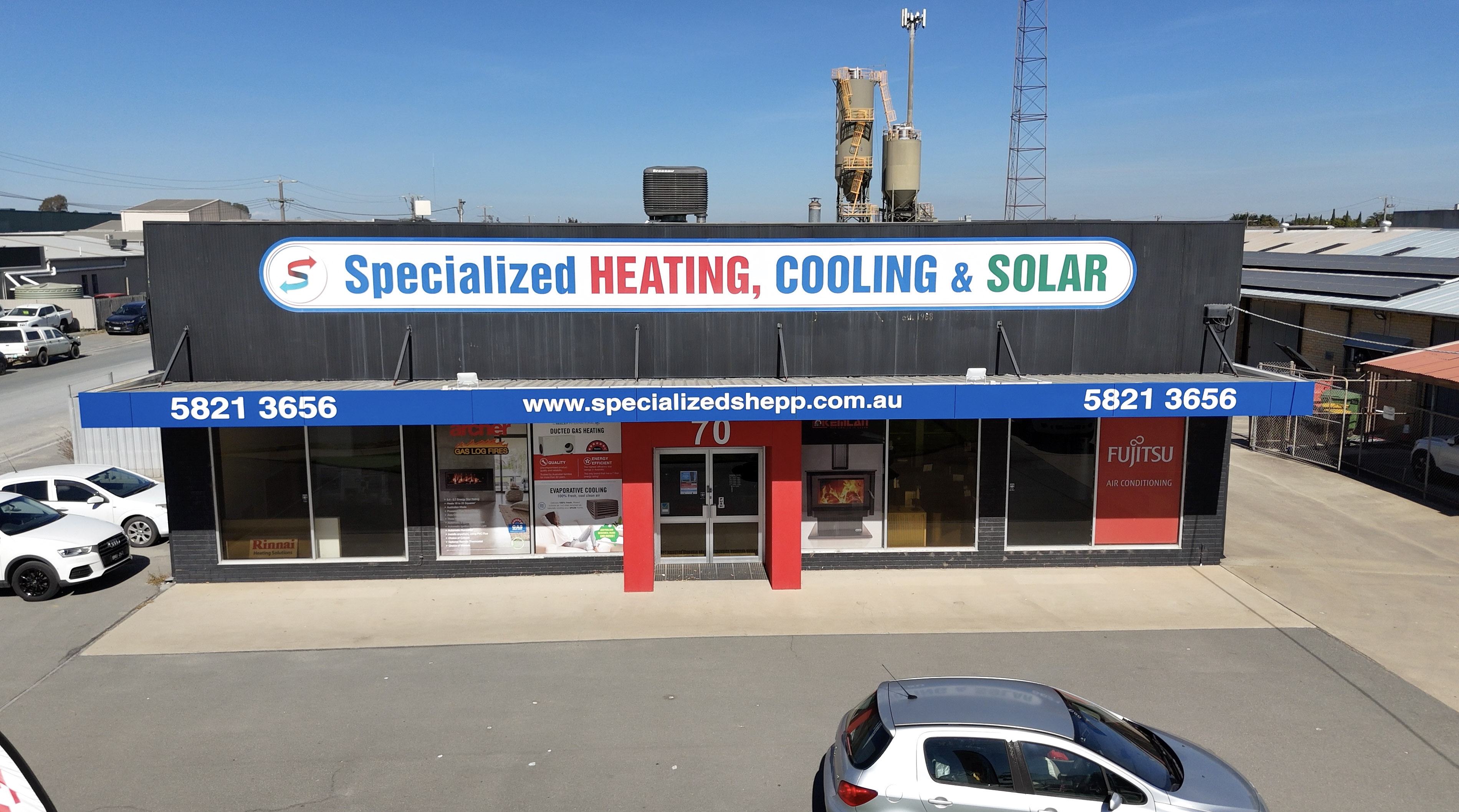 Building with a sign for Specialized Heating, Cooling & Solar and website www.specializedshepp.com.au