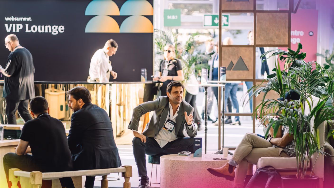 A large stage viewed over the silhouetted heads of a packed audience. A line of people stands on the stage, facing towards the audience. Confetti fills the air. A large Web Summit Rio logo hangs in the center of the stage. Two screens on either side of the logo read 'That's all for today!'