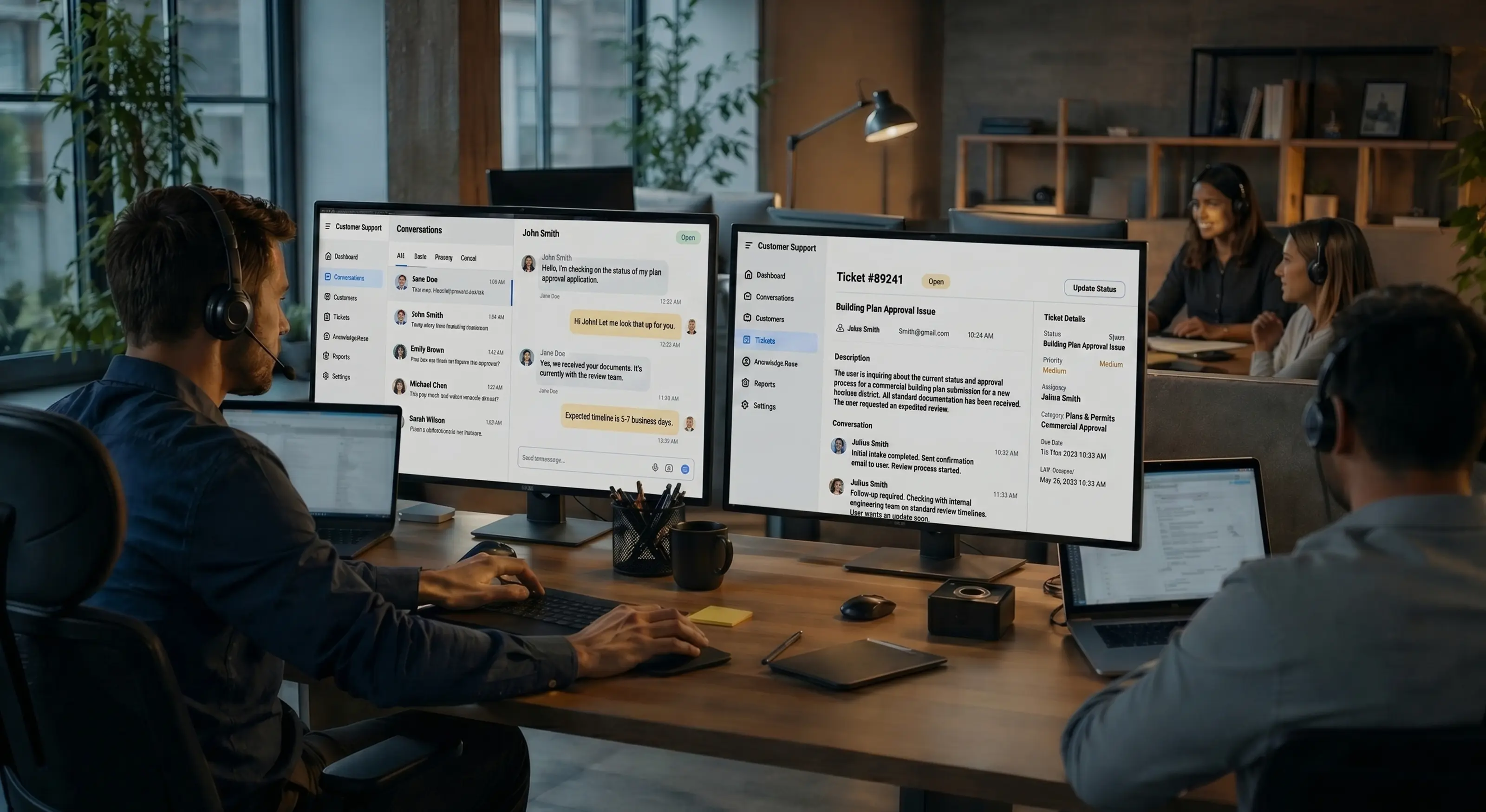 Customer support agents wearing headsets working at desks with dual monitors displaying chat and ticketing software.