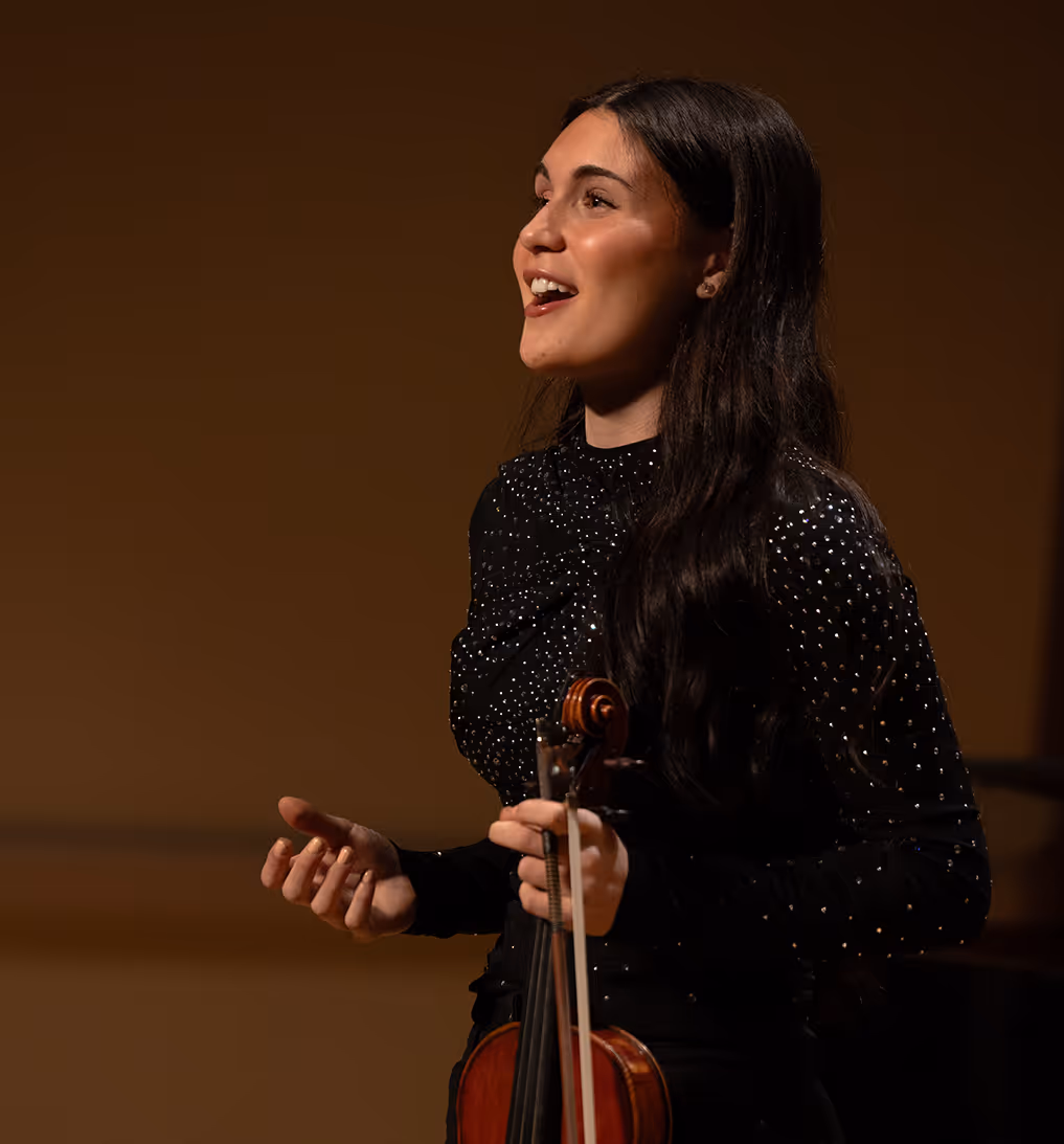 Nesya playing violin, facing right
