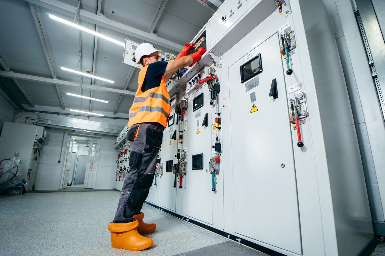 Electrical service technician working on commercial equipment