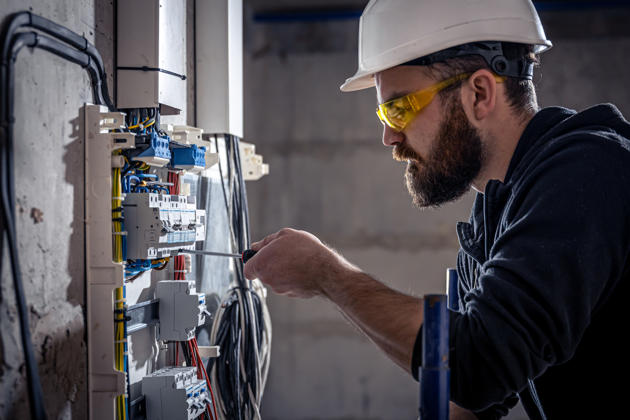 Electrician working on an electrical panel