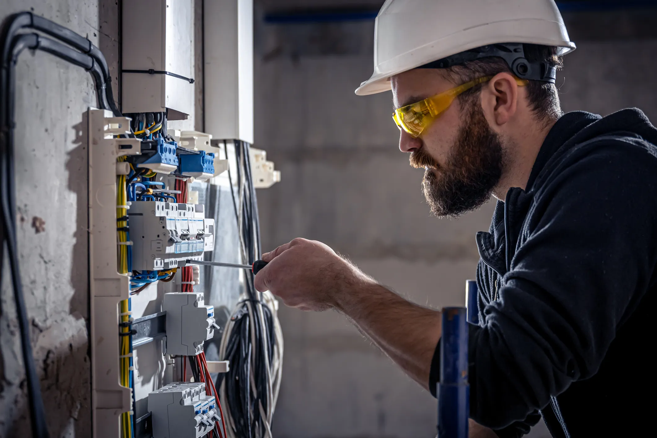Electrician working on an electrical panel