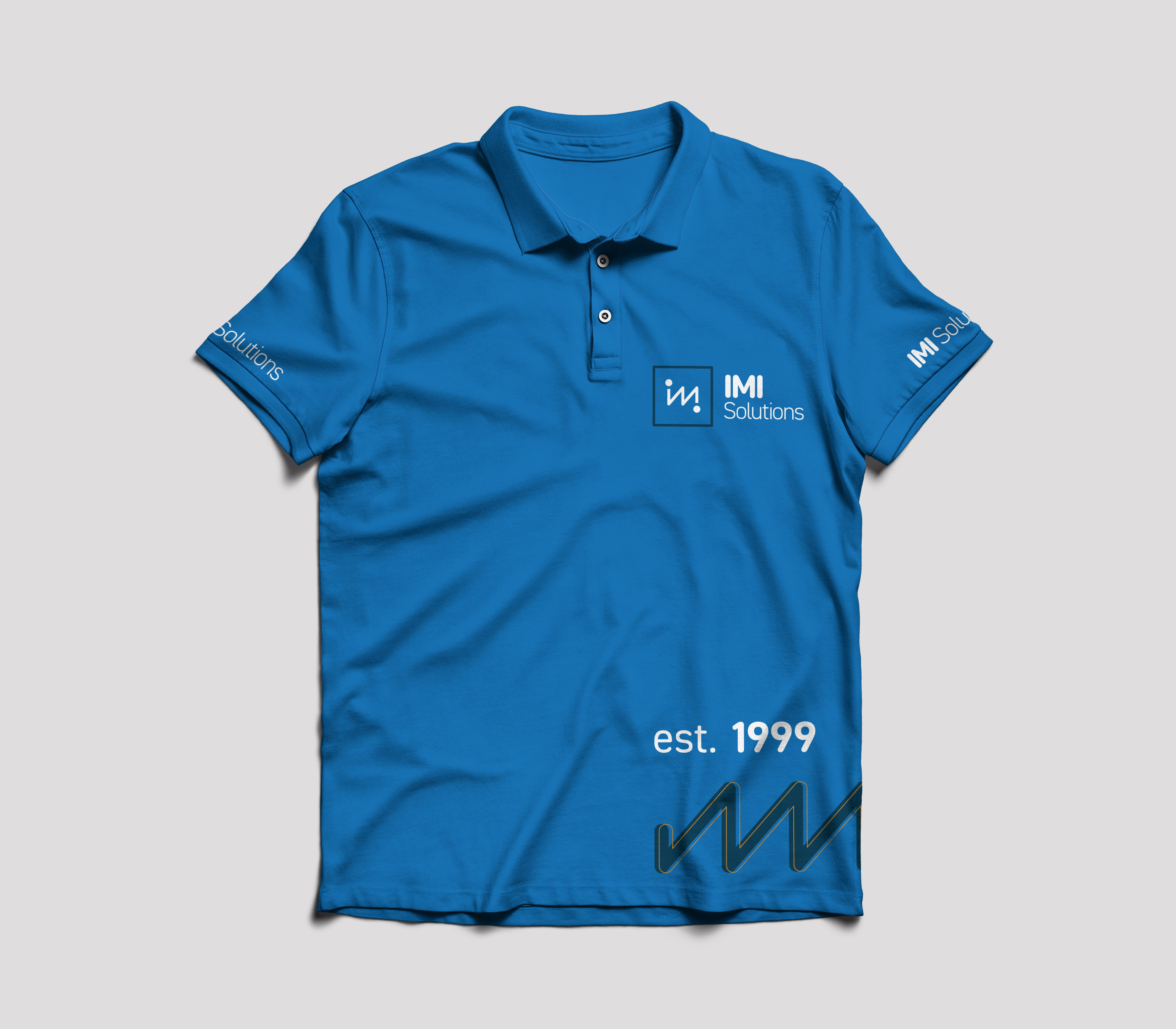 Blue polo shirt with IMI Solutions logo on the chest and sleeves, and text 'est. 1999' near the hem.