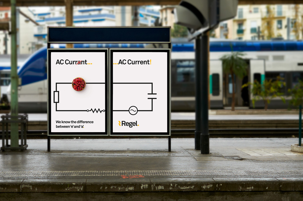 Two side-by-side posters at a train station comparing the misspelling 'AC Currant' with a photo of red currants and the correct term 'AC Current' with an electrical circuit symbol, highlighting the difference between 'e' and 'a'.
