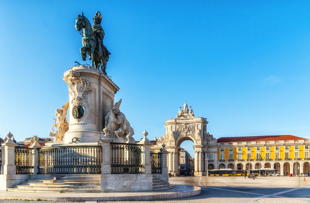 Equestrian statue of King José I in Lisbon Commerce Square with Augusta Arch under blue sky