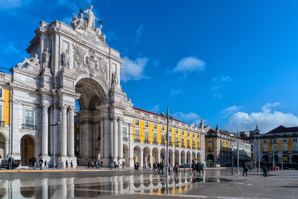 The Rua Augusta Arch and the bright yellow buildings of Commerce Square in Lisbon