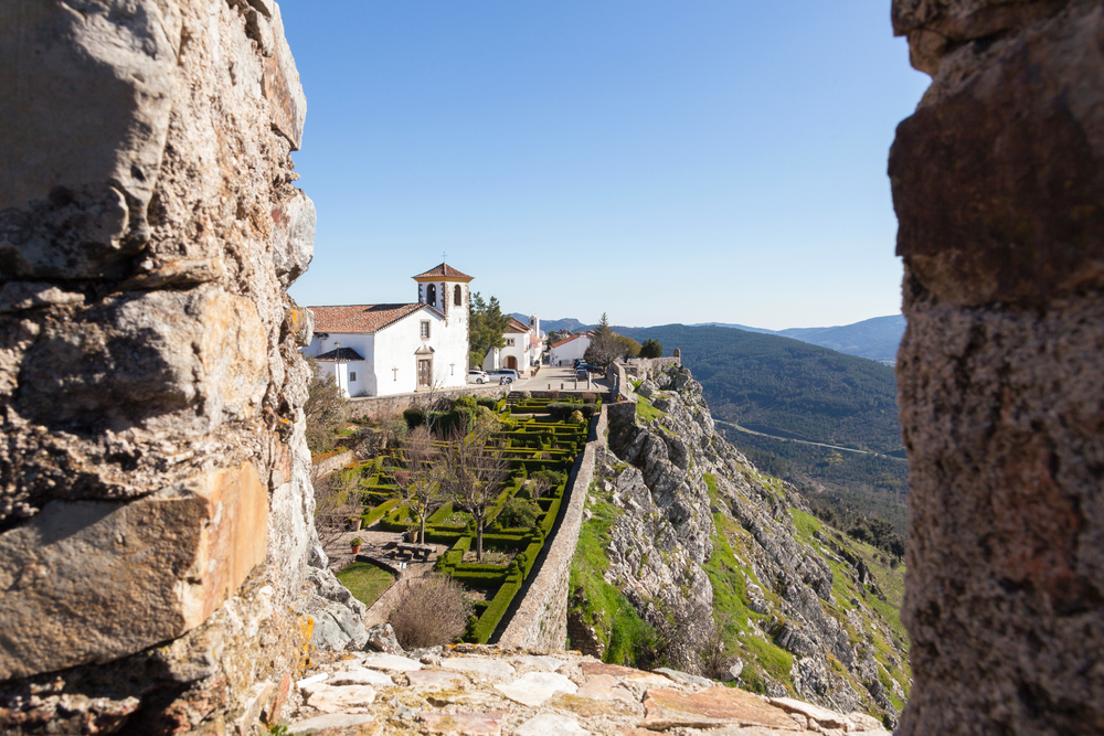Marvão church seen through window castle wall, on a sunny day with a blue sky