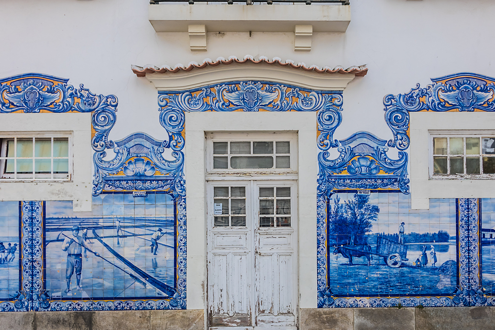 Aveiro's historic train station facade with traditional azulejo tiles depicting regional life scenes