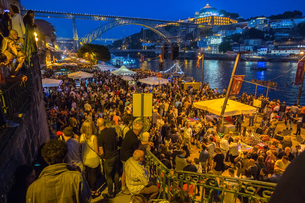 Porto's riverside packed with people celebrating São João festival with music and tents