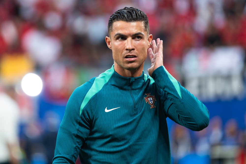 Portugal team captain Cristiano Ronaldo gestures with his hand to his ear on the football pitch