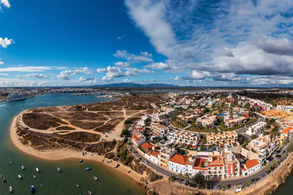 Aerial panorama of Ferragudo village along the Arade River estuary