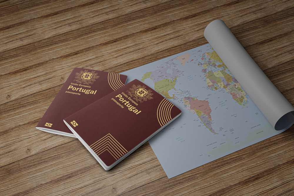Two Portugal passports on top of a map of the world