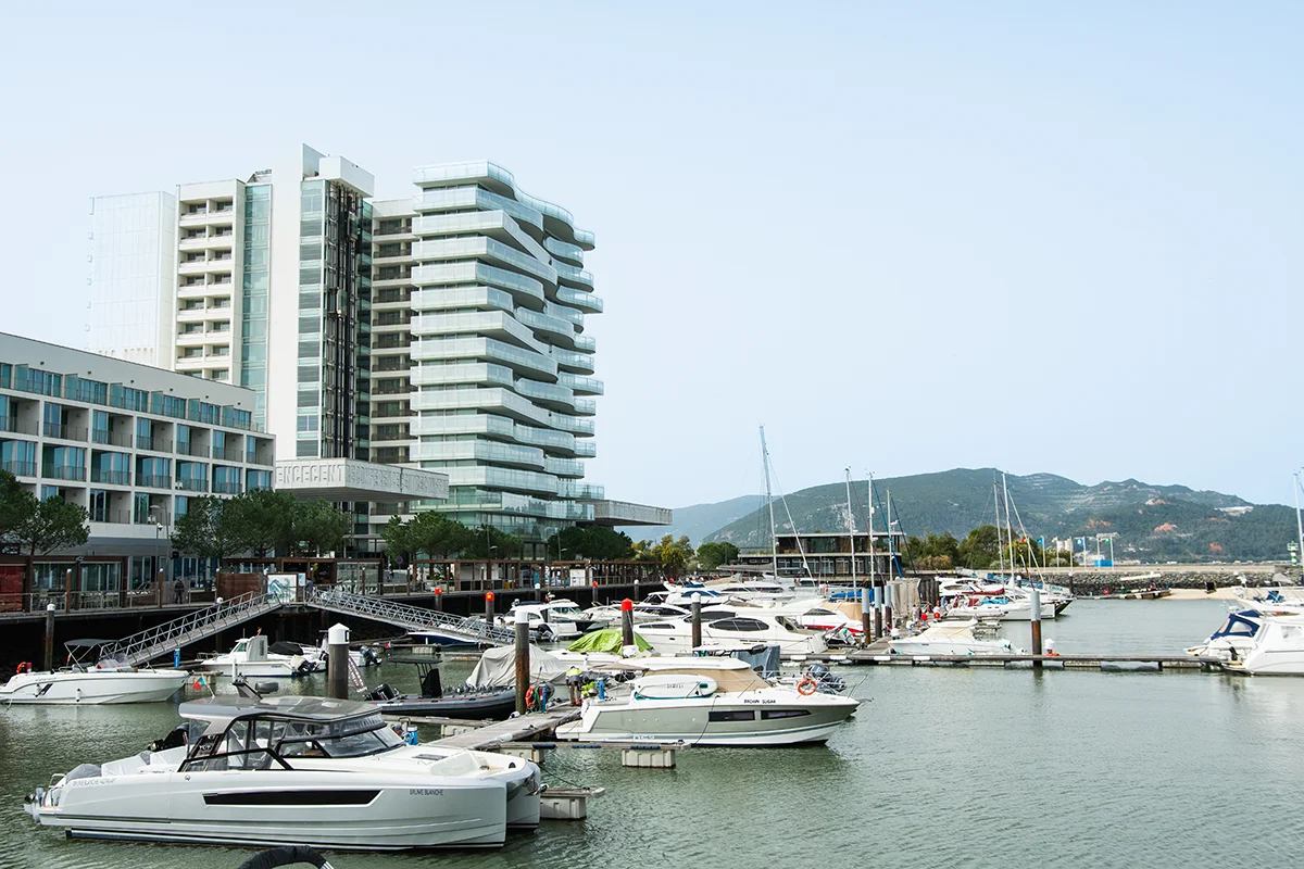 Modern Troia Design Hotel and marina, with luxury yachts docked on the waterfront