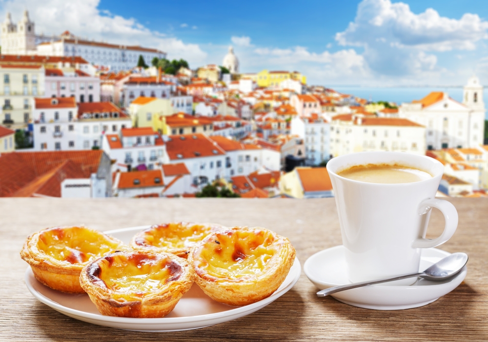 Coffee and pastel de natas in Portugal overlooking Lisbon skyline