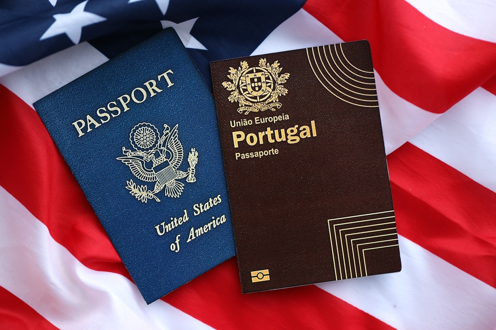 Portugal passport and USA passport on USA flag