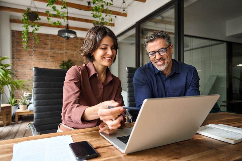 Entrepreneur and tax advisor looking at options on a laptop