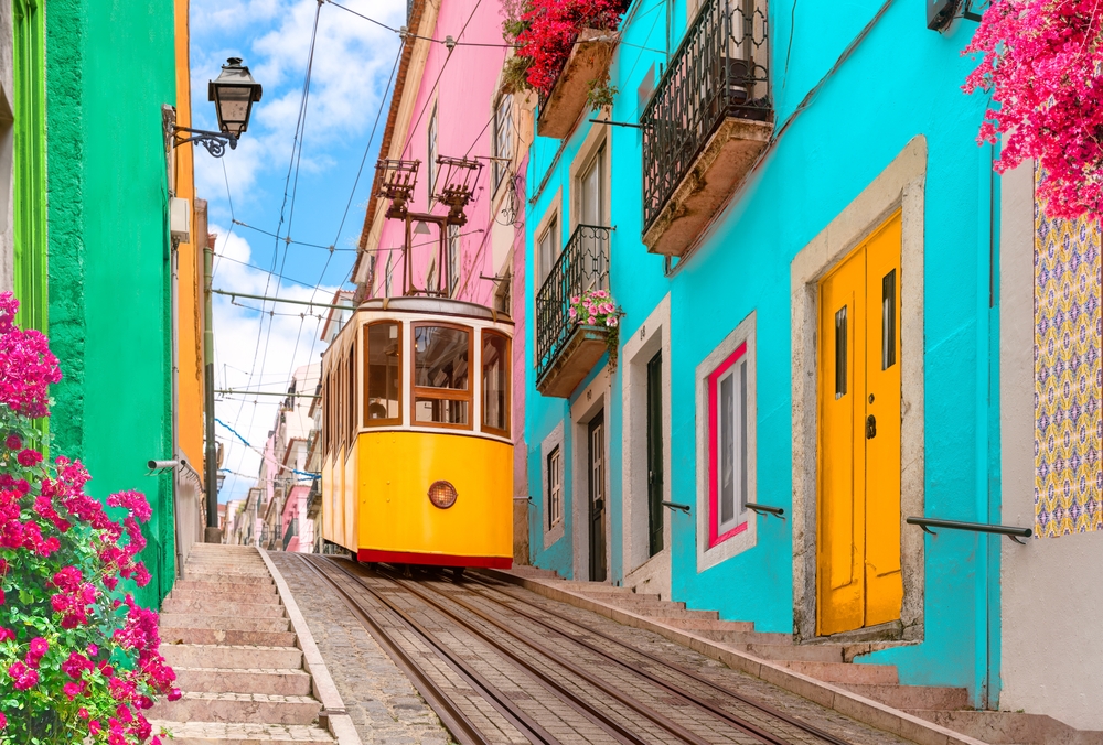 Colorful buildings and tram in Chiado, Lisbon, showcasing vibrant architecture and urban transport.