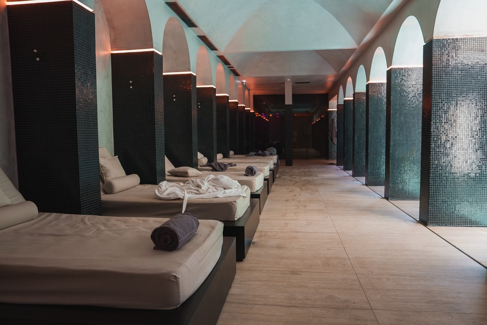 Wellness area in luxury Portuguese property with tiled arches and relaxation beds.
