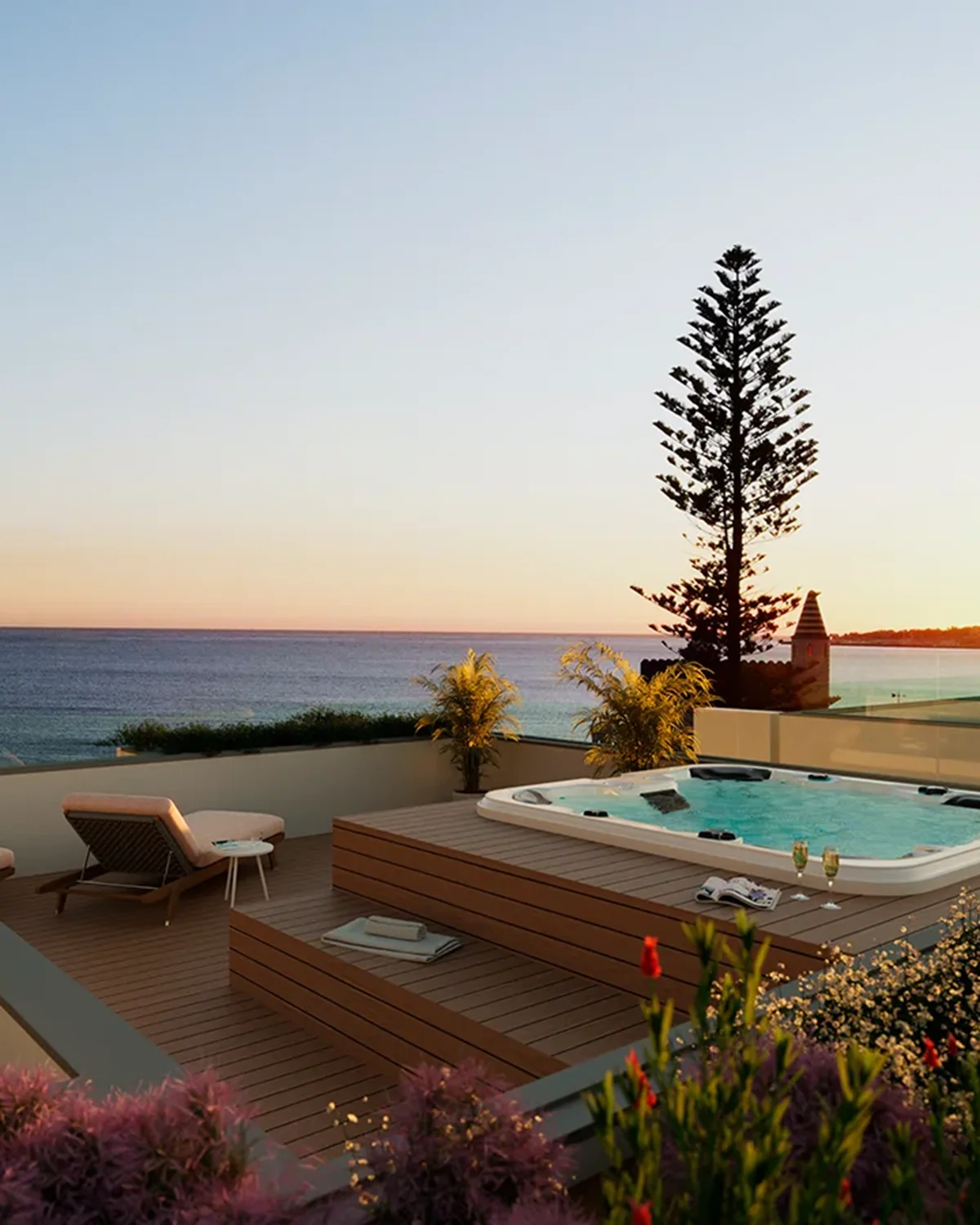 Luxury Ocean 7 development exterior with jacuzzi, lounge chairs and coastal sunset view in Portugal.