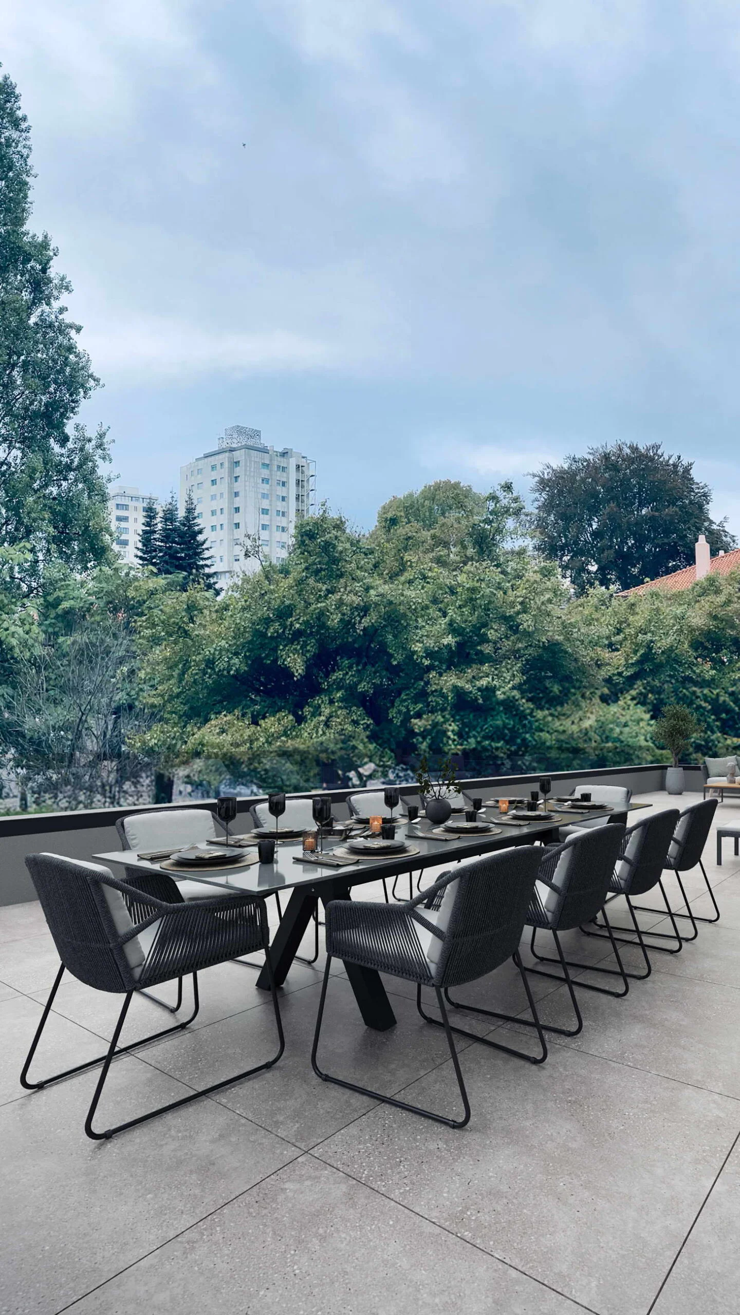 Luxury apartment balcony with dining table and chairs overlooking Porto cityscape