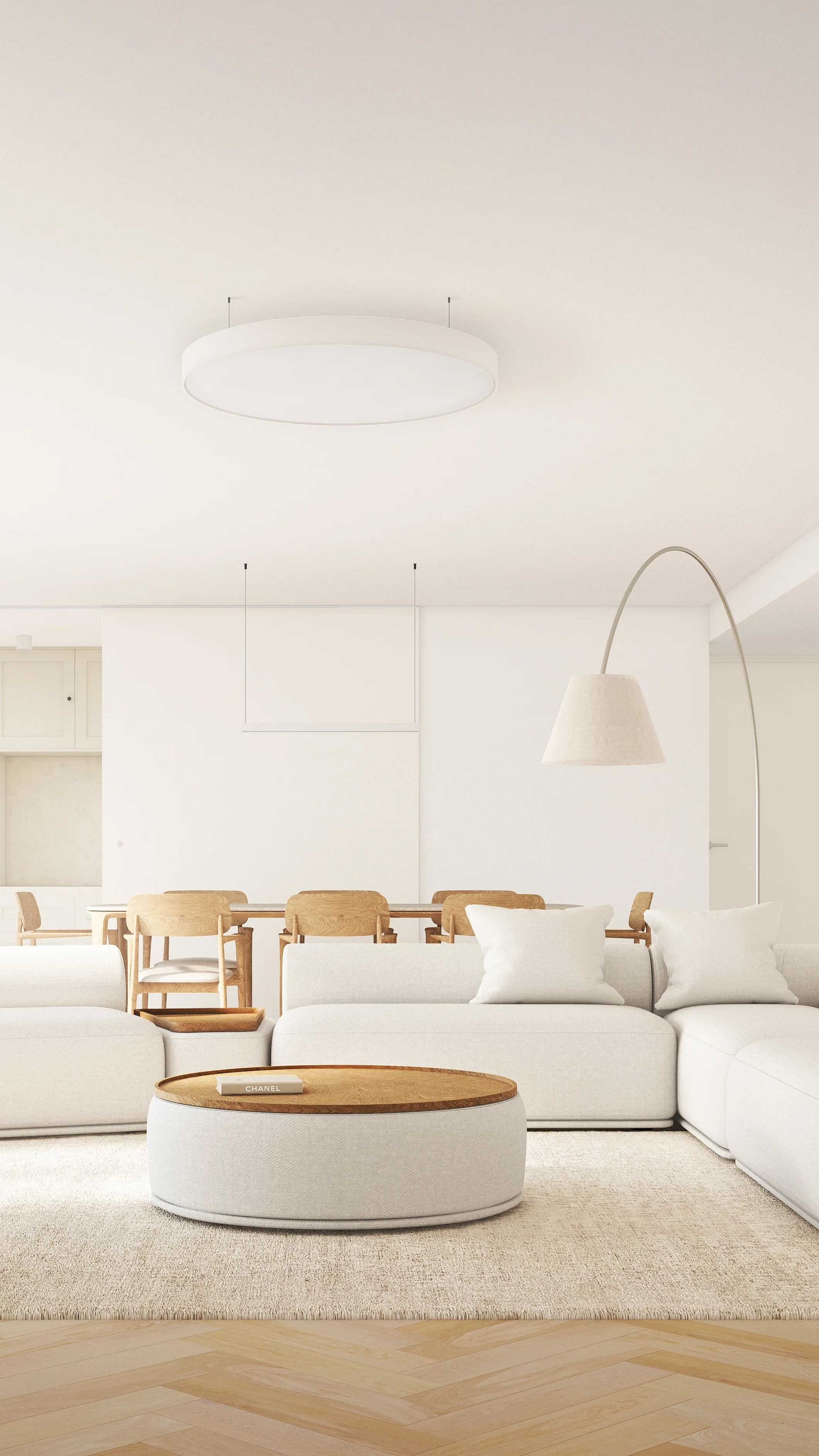 Modern living room interior with white sofa, wooden coffee table, and arched floor lamp.