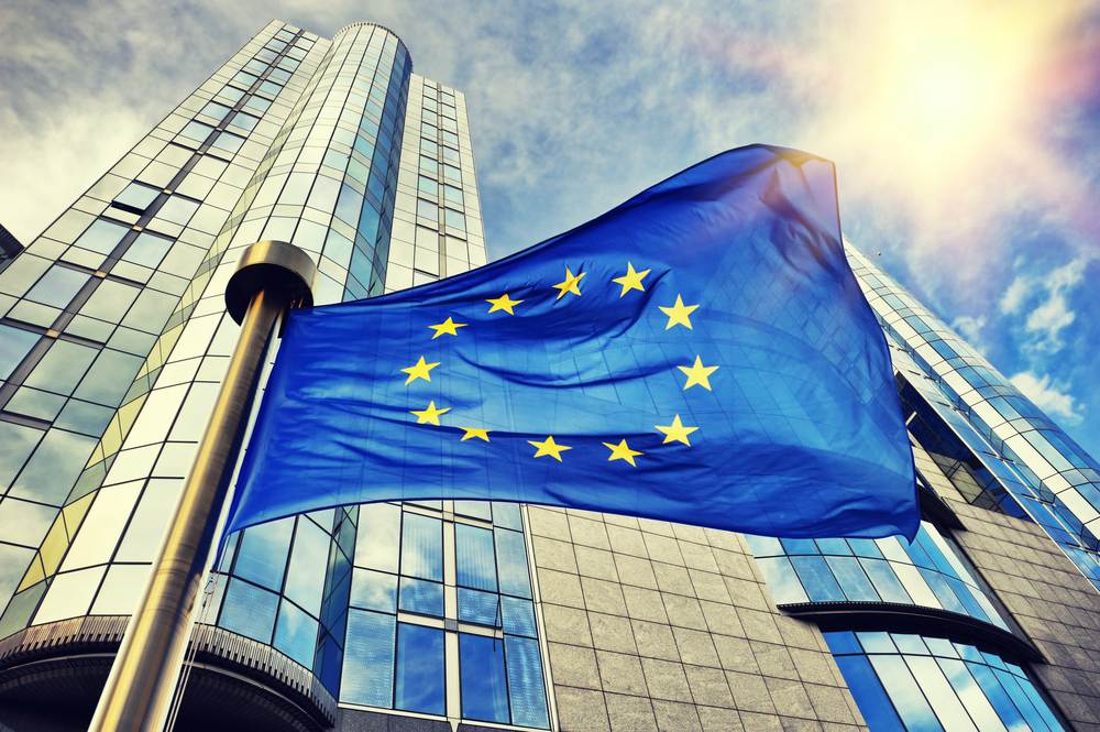 EU flag in front of modern office buildings