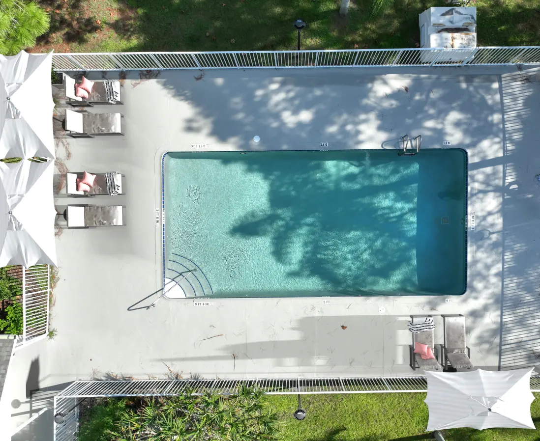Overhead view of swimming pool with lounge chairs
