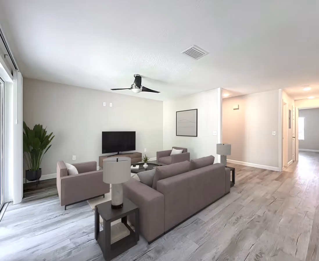Living area with virtually staged sofa, coffee table, and chairs