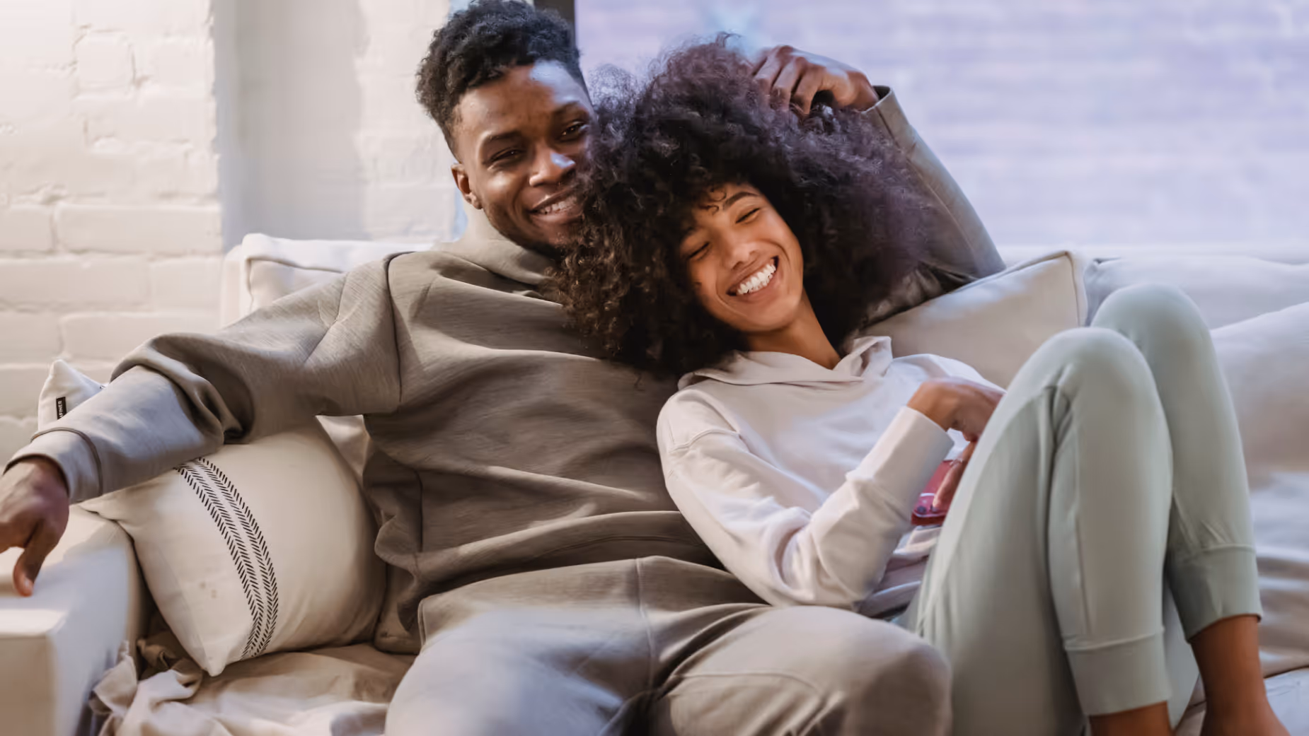 Couple on sofa smiling stock image