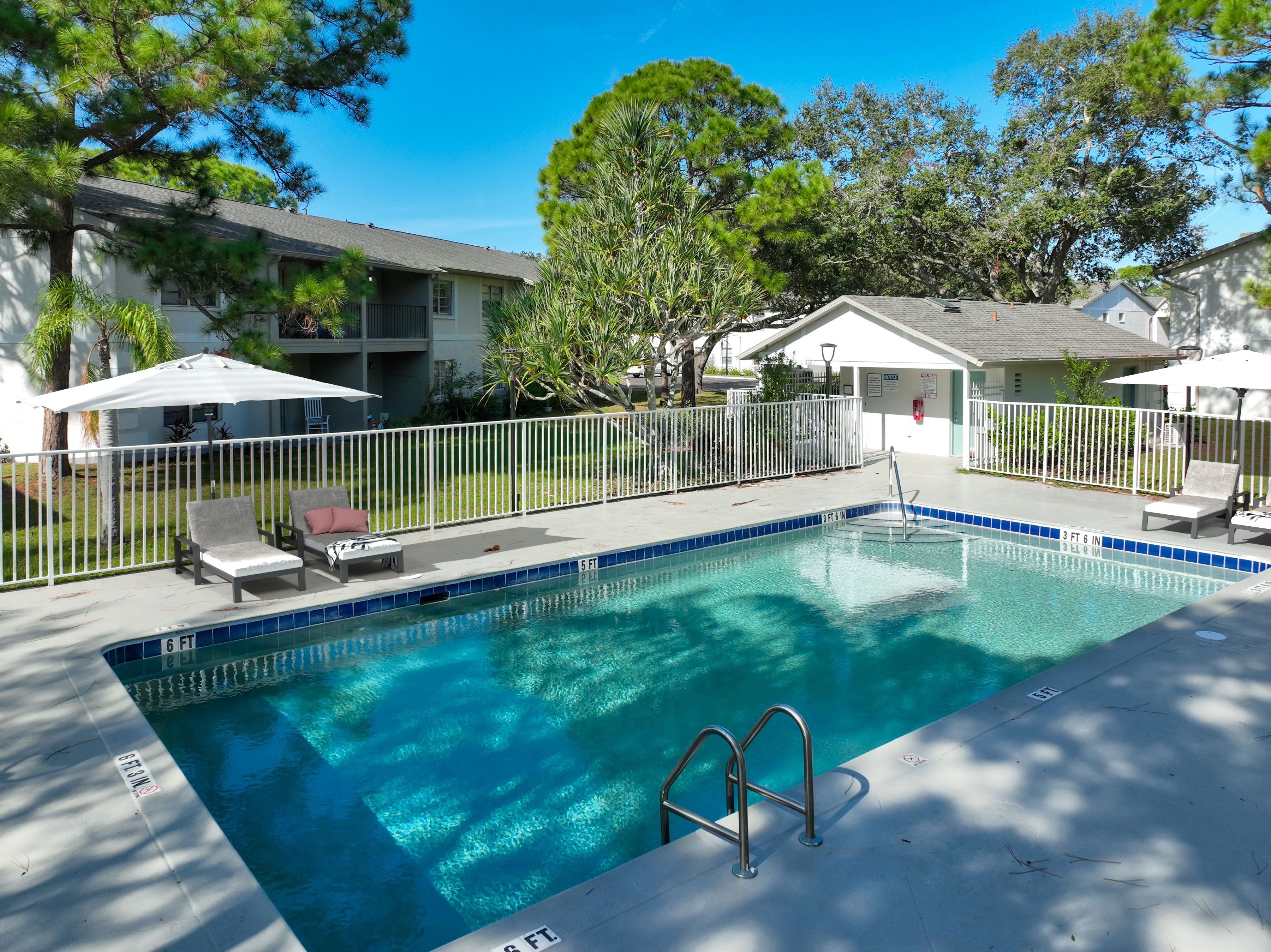 Swimming pool with view of exterior and trees