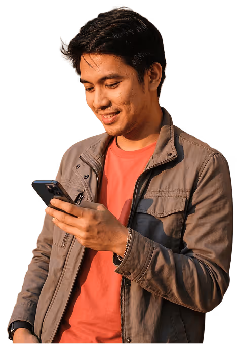 Smiling young man in brown jacket looking at smartphone in his hand.