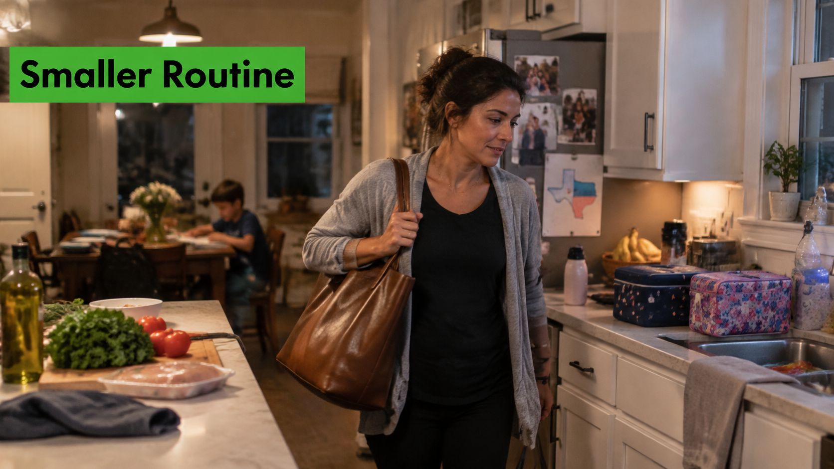 A woman carries a brown leather bag in her home kitchen after returning from work.