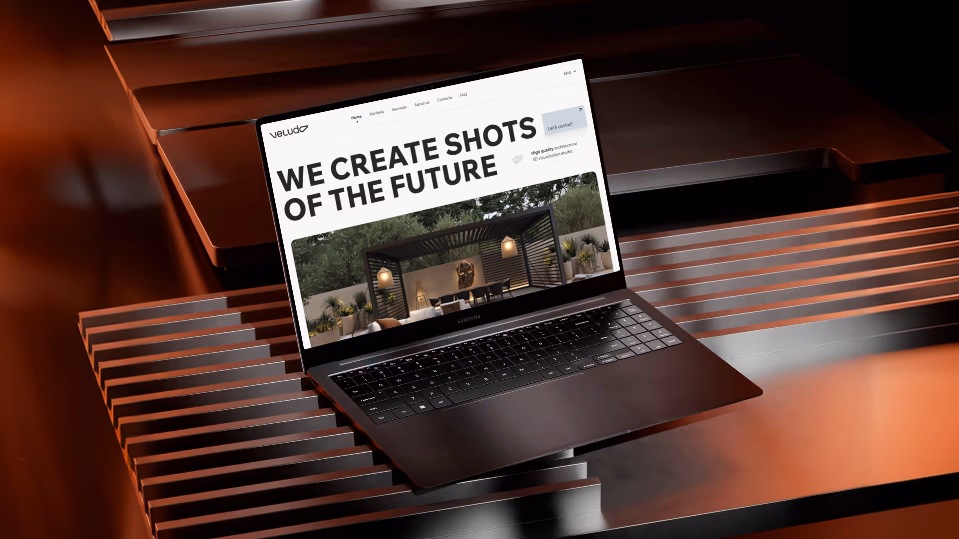Ноутбук із відкритим вебсайтом студії 3D-візуалізації Veludo з написом «Ми створюємо кадри майбутнього».