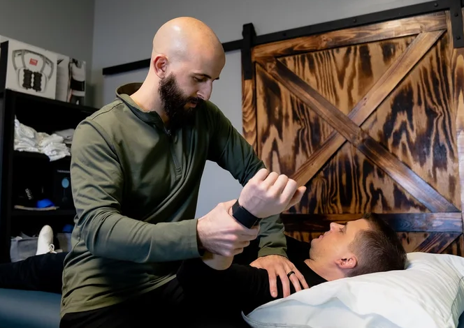  Patient receiving one-on-one manual therapy at a sports physical therapy clinic in Rockville Centre, NY