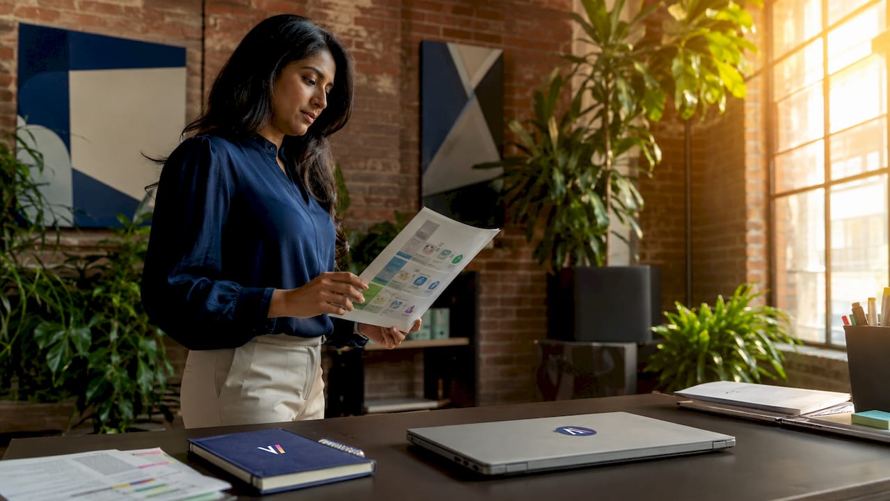 Woman analyzing AI support agent data at desk