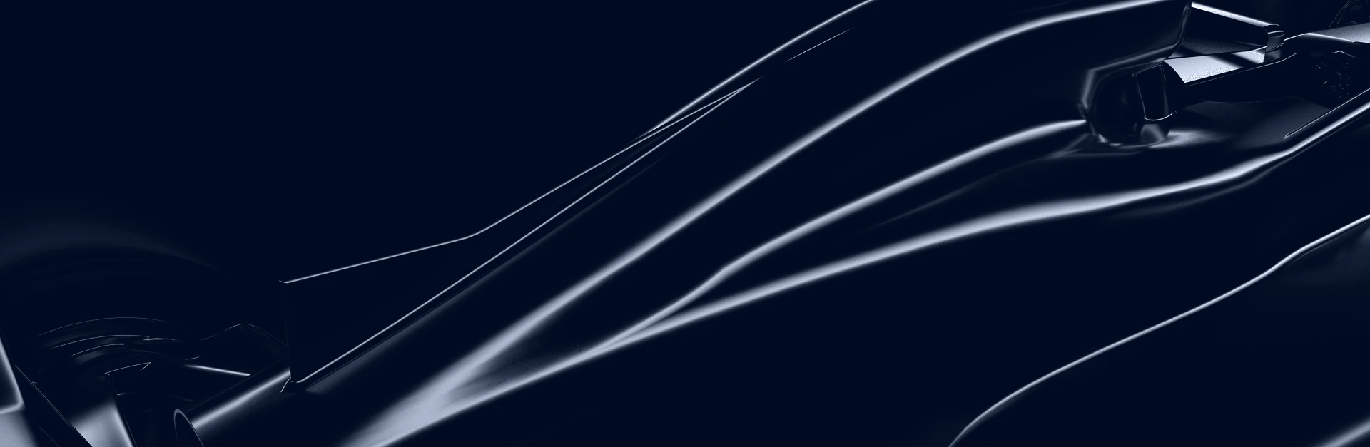 Close-up of a sleek, dark-colored Formula 1 race car body with reflective light streaks.
