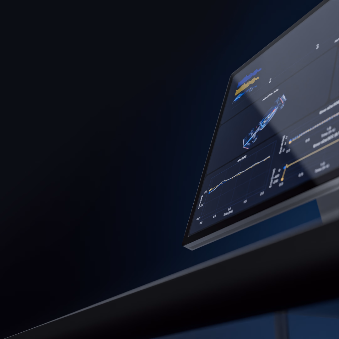Close-up of a computer monitor displaying charts and graphs against a dark background.