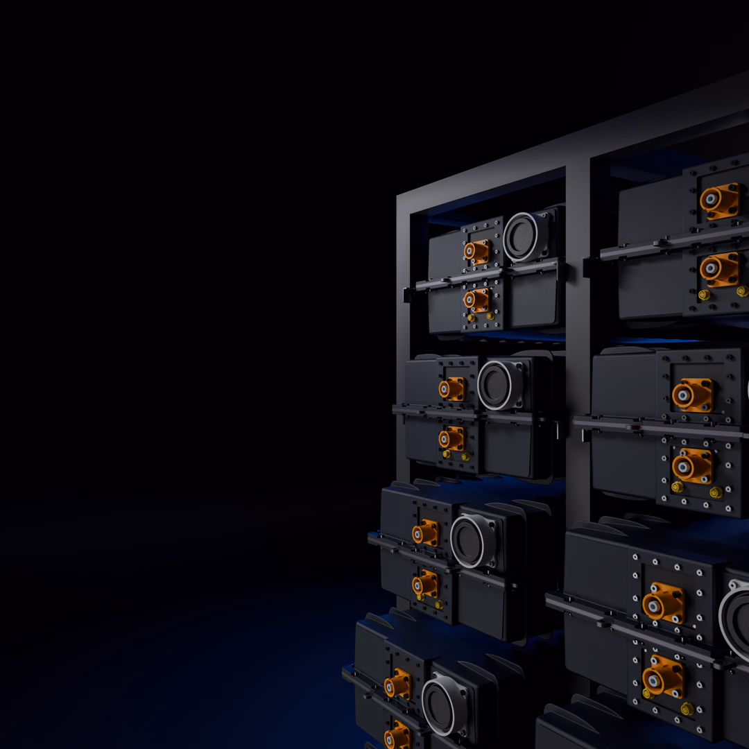 Close-up of a modular battery pack with black casing and orange connectors on a dark background.