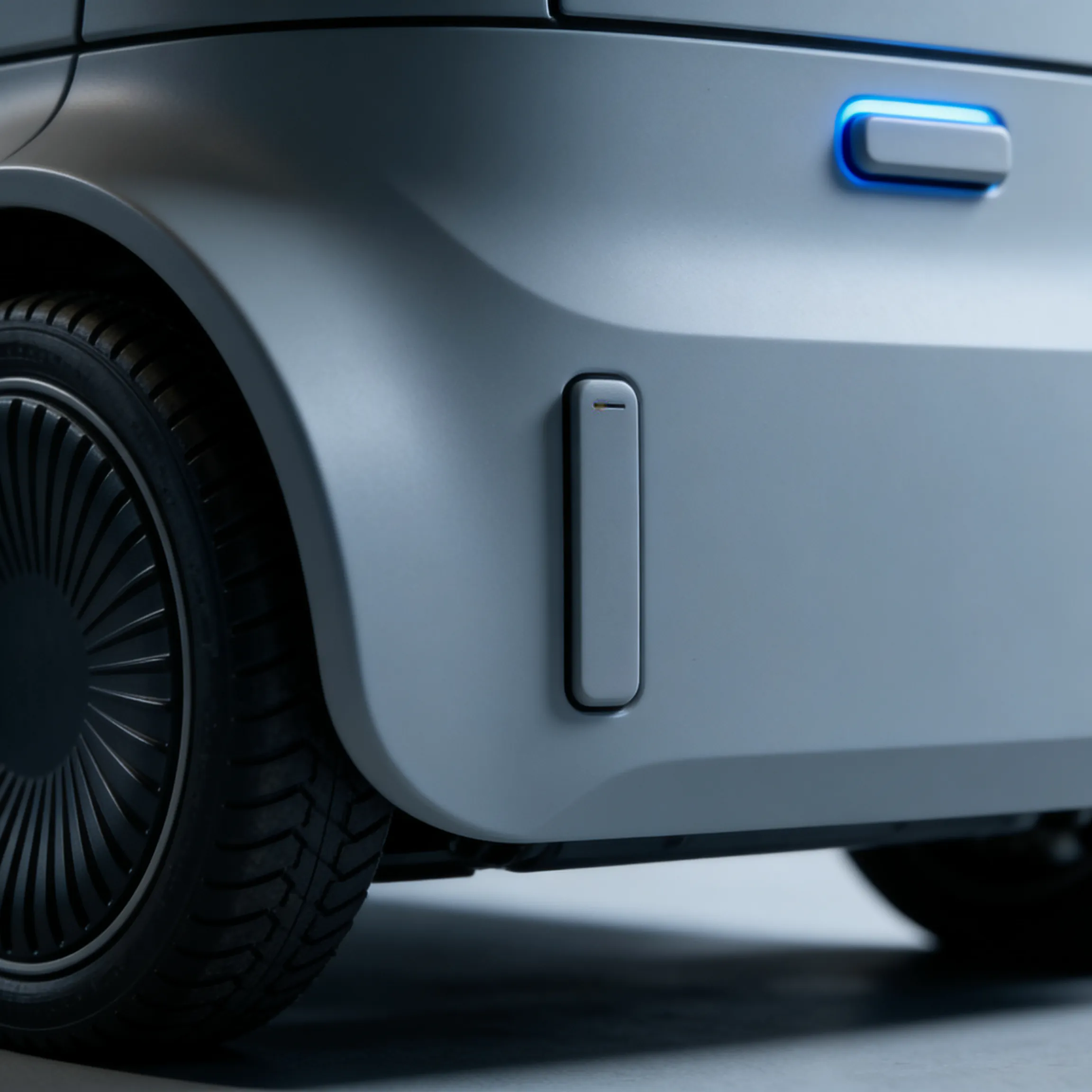 Close-up of a gray vehicle's rear wheel and side panel with a blue-lit handle.