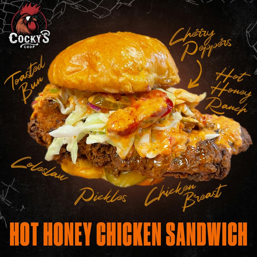 Hot honey chicken sandwich with toasted bun, fried chicken breast, pickles, coleslaw, cherry peppers, and hot honey ranch sauce.